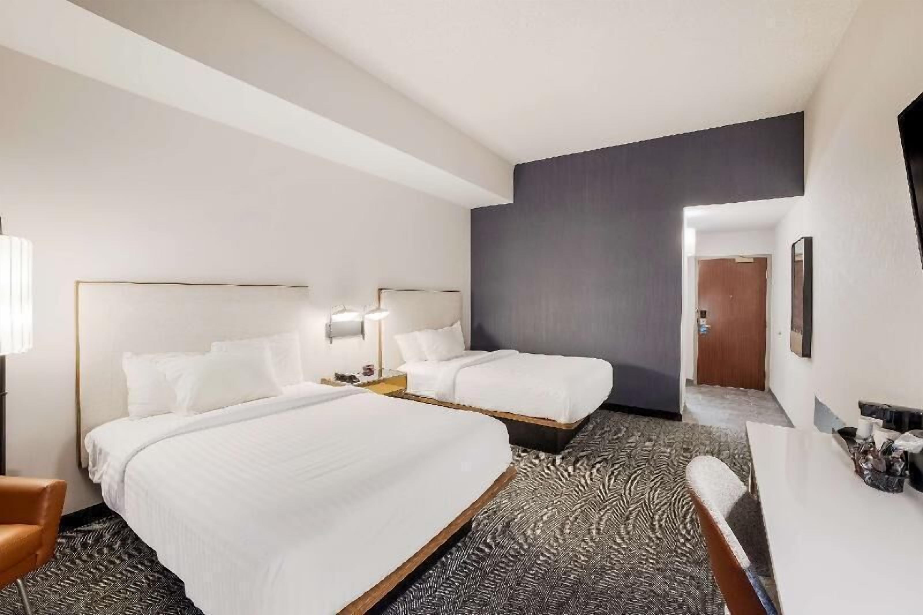Premium bedding, desk, laptop workspace, blackout drapes