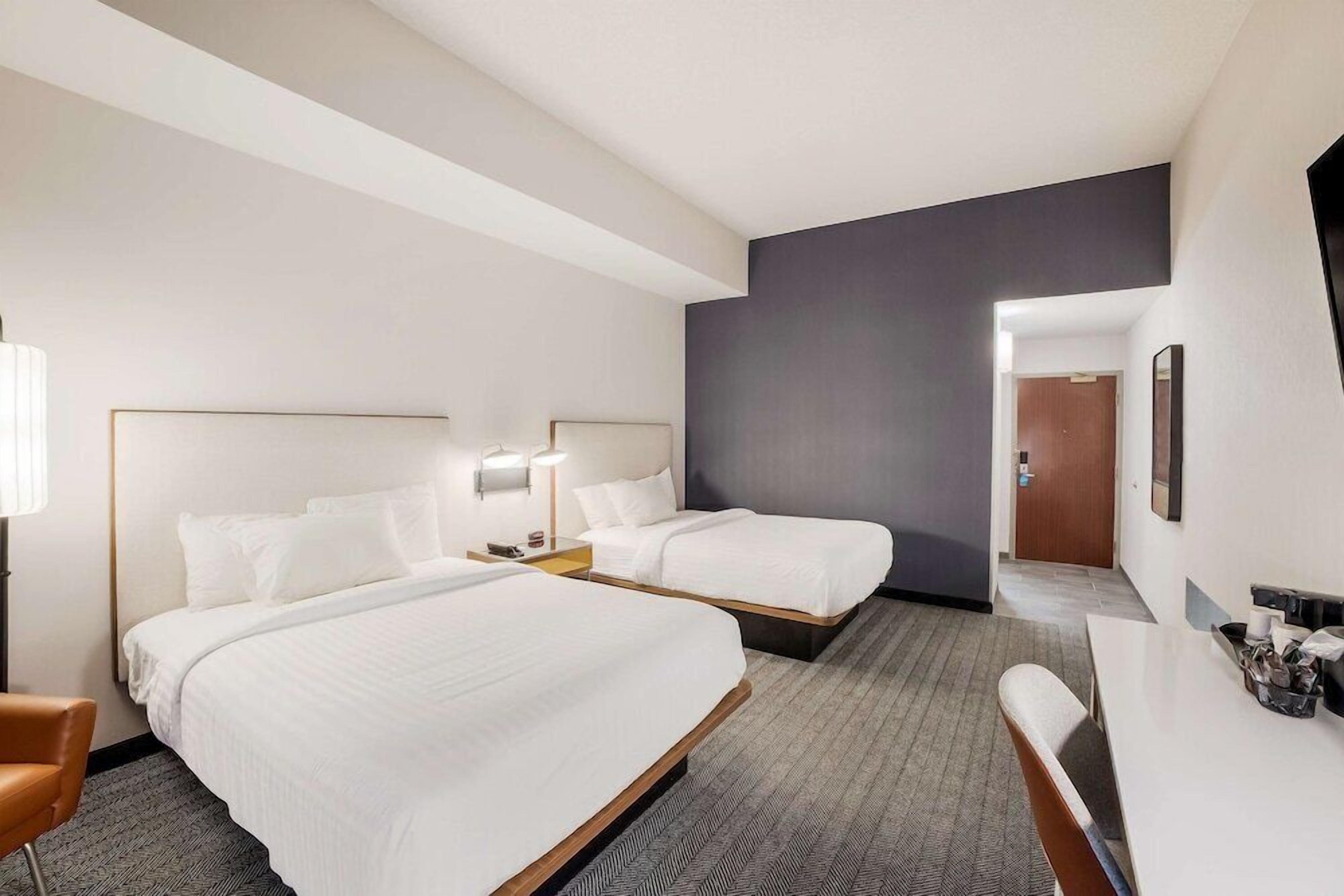 Premium bedding, desk, laptop workspace, blackout drapes