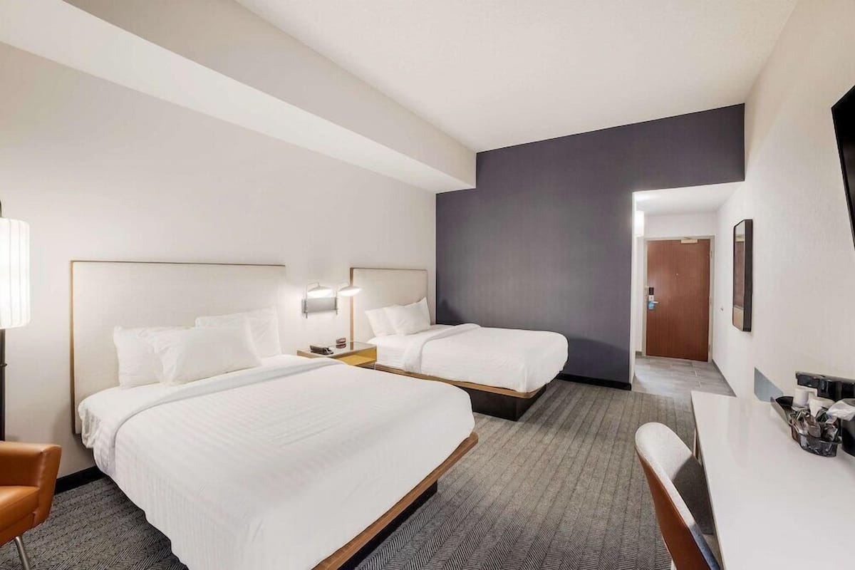 Premium bedding, desk, laptop workspace, blackout curtains