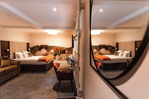 Relax in a serene bedroom with a large bed and matching headboard, complemented by a convenient desk for work.