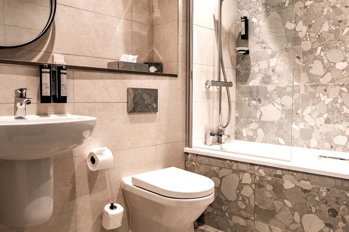 designer toiletries, hair dryer, towels, soap