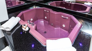 Un cuarto de spa con varias tinas y una pared espejada.