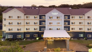 A multi-story hotel with a central entrance and a covered outdoor area.