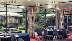 A conference room with tables and chairs, a projector screen, and a presentation board. - Mercure Norwich Hotel (Norwich)