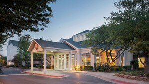 A hotel with a covered entrance, a clear sky, and well-maintained landscaping. - Hilton Garden Inn Bentonville Rogers (Bentonville)