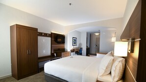 A hotel room with a large bed, wooden wardrobe, desk, chair, and a television. - Holiday Inn Express Hotel & Stes Port Clinton-Catawba Island by IHG (Port Clinton)