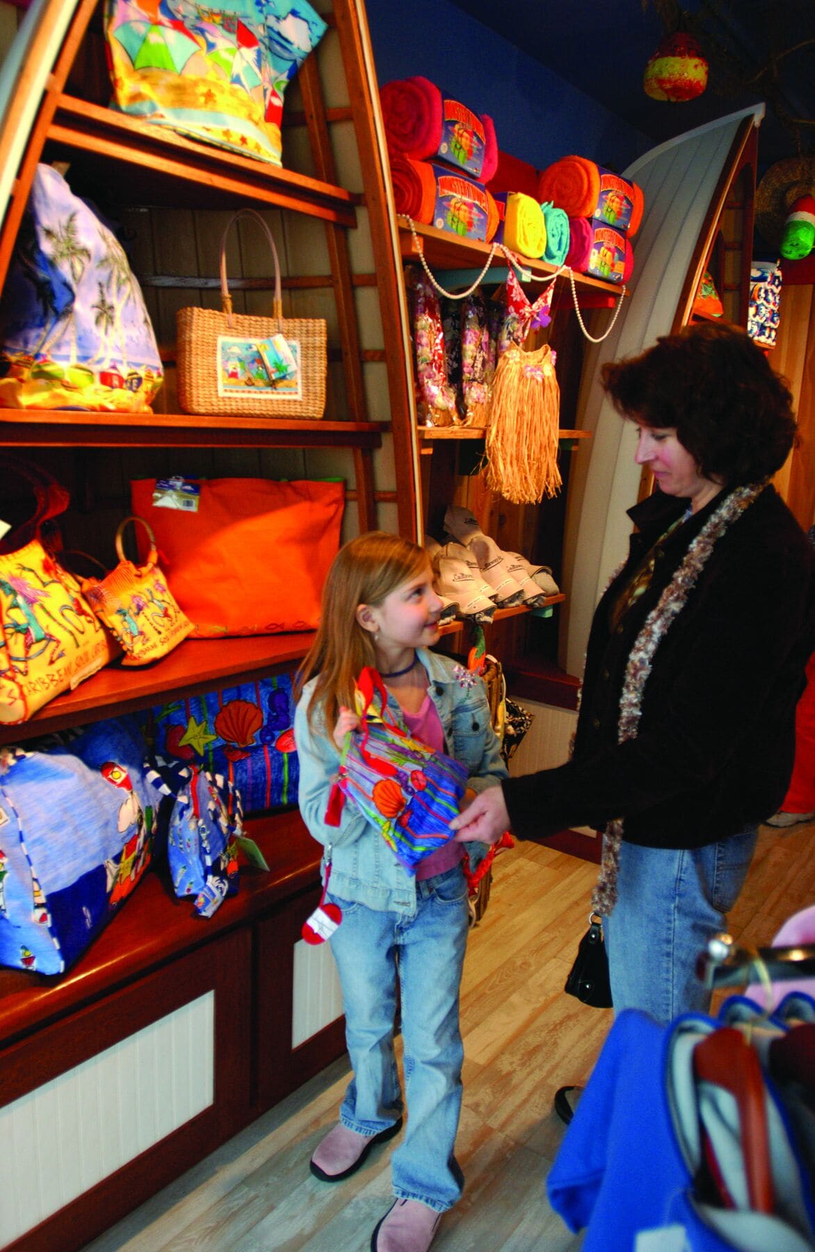 A store interior with shelves displaying colorful bags and accessories.