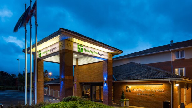 A Holiday Inn Express building with a covered entrance and a visible sign. - Holiday Inn Express Gloucester - South by IHG (Gloucester)