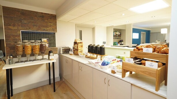 A breakfast buffet area with various food items and a coffee station. - Holiday Inn Express Leeds East by IHG (Leeds)