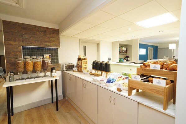 A breakfast buffet area with various food items and a coffee station. - Holiday Inn Express Leeds East by IHG (Leeds)