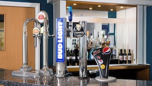 A bar counter with multiple taps including Bud Light, Guinness, Stella Artois, and Pepsi Max. - Holiday Inn Express Manchester East by IHG (Manchester)