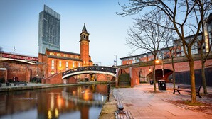 A historic building with a clock tower, a bridge, and a modern skyscraper in the background. - Holiday Inn Express Manchester East by IHG (Manchester)