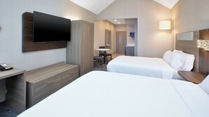 A hotel room with a bed, a desk, a TV, a wardrobe, and a bathroom visible through an open door. - Holiday Inn Express & Suites Youngstown N (Warren/Niles) by IHG (Warren)