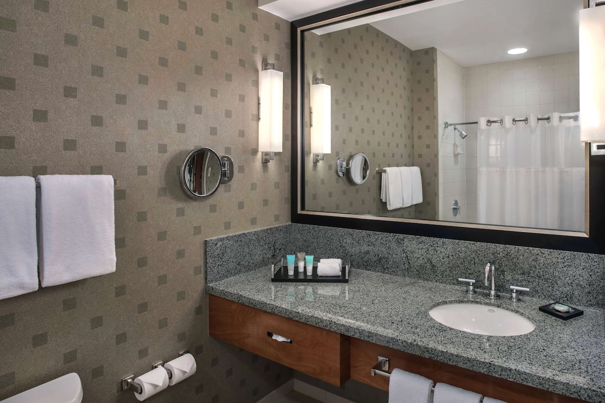 designer toiletries, hair dryer, towels, soap