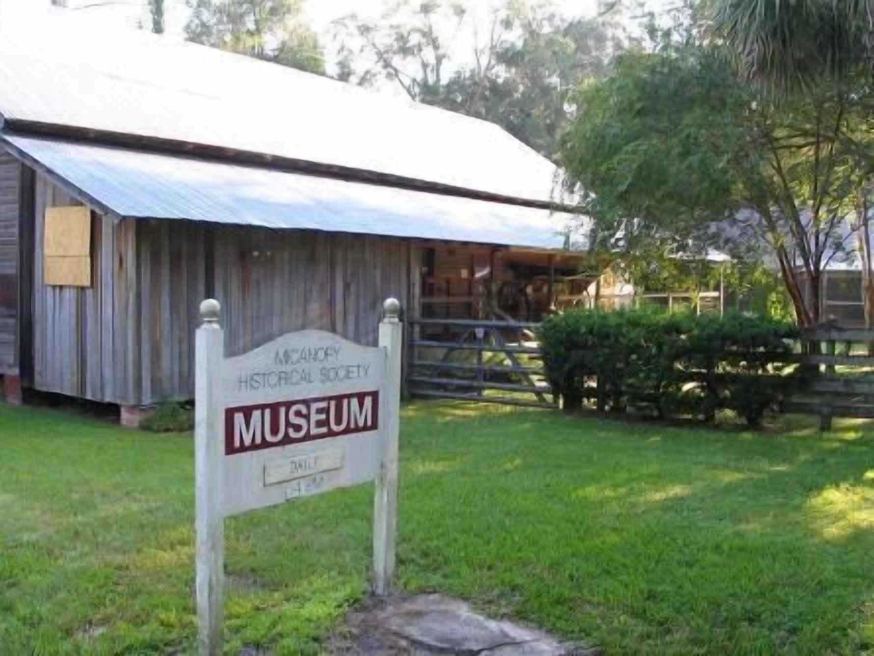 A wooden building with a sign for the McCanley Historical Society Museum.