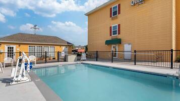 Quality Inn offers a refreshing pool experience with a clear water surface surrounded by a fence.