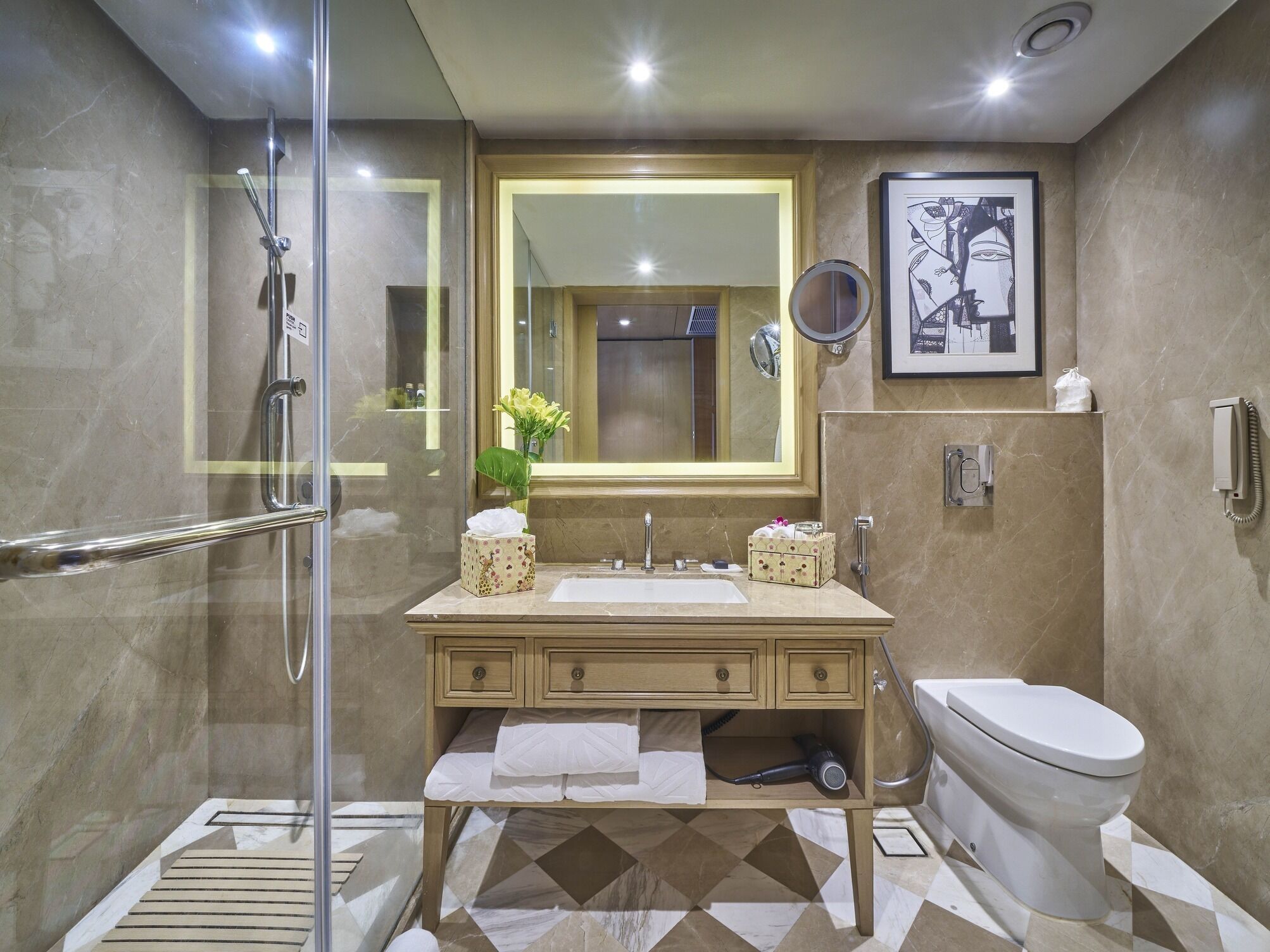 A modern bathroom with a glass shower enclosure, a vanity with a sink and mirror, a toilet, and a patterned floor.