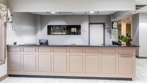 A reception desk with a sign reading 'QUALITY INN & SUITES BY CHOICE HOTELS.' - Quality Inn & Suites Conference Center (Thomasville)