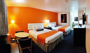A hotel room with two beds, a desk, a chair, and a lamp. - Howard Johnson by Wyndham Holbrook (Holbrook)