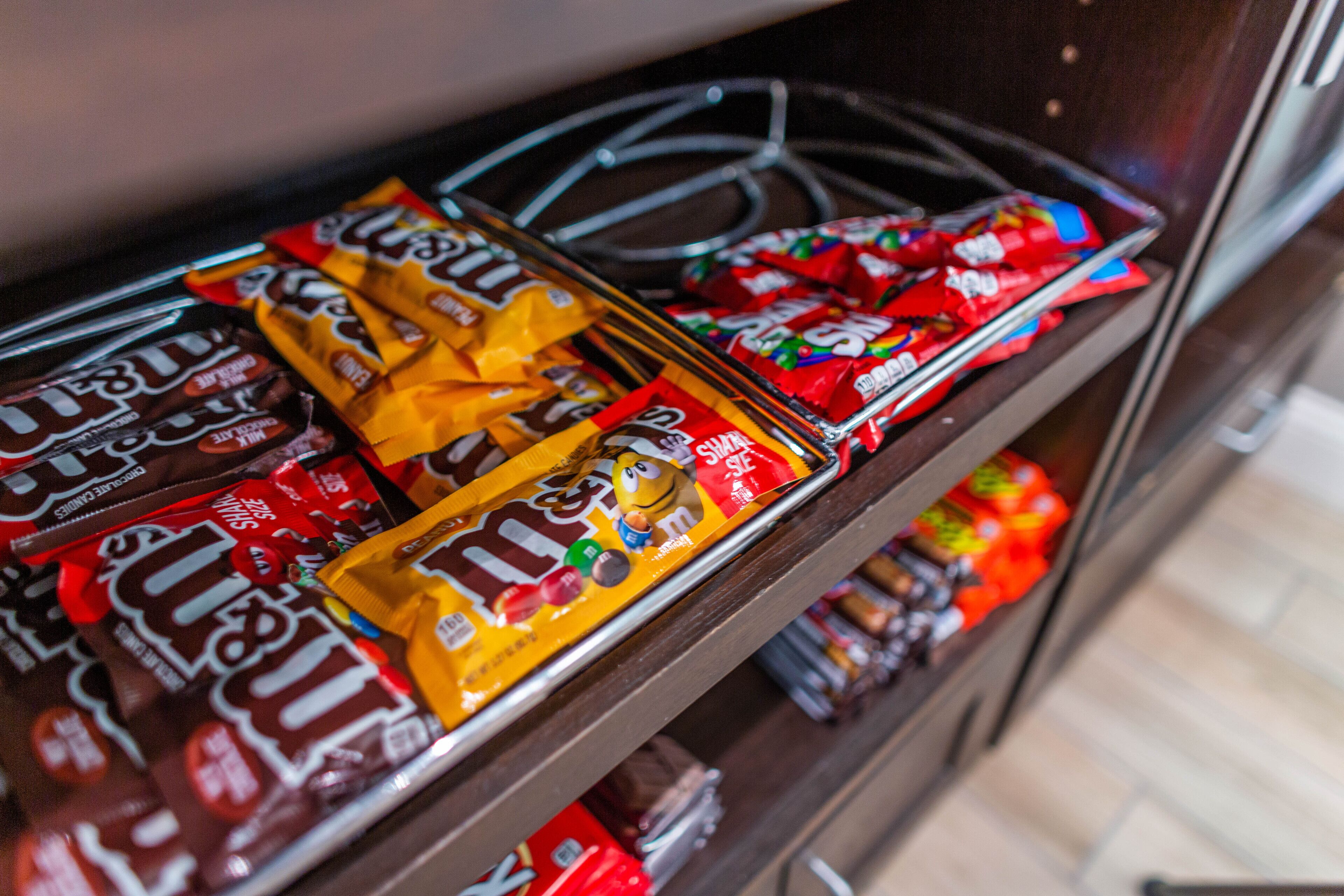 A shelf with various chocolate bars and snacks.
