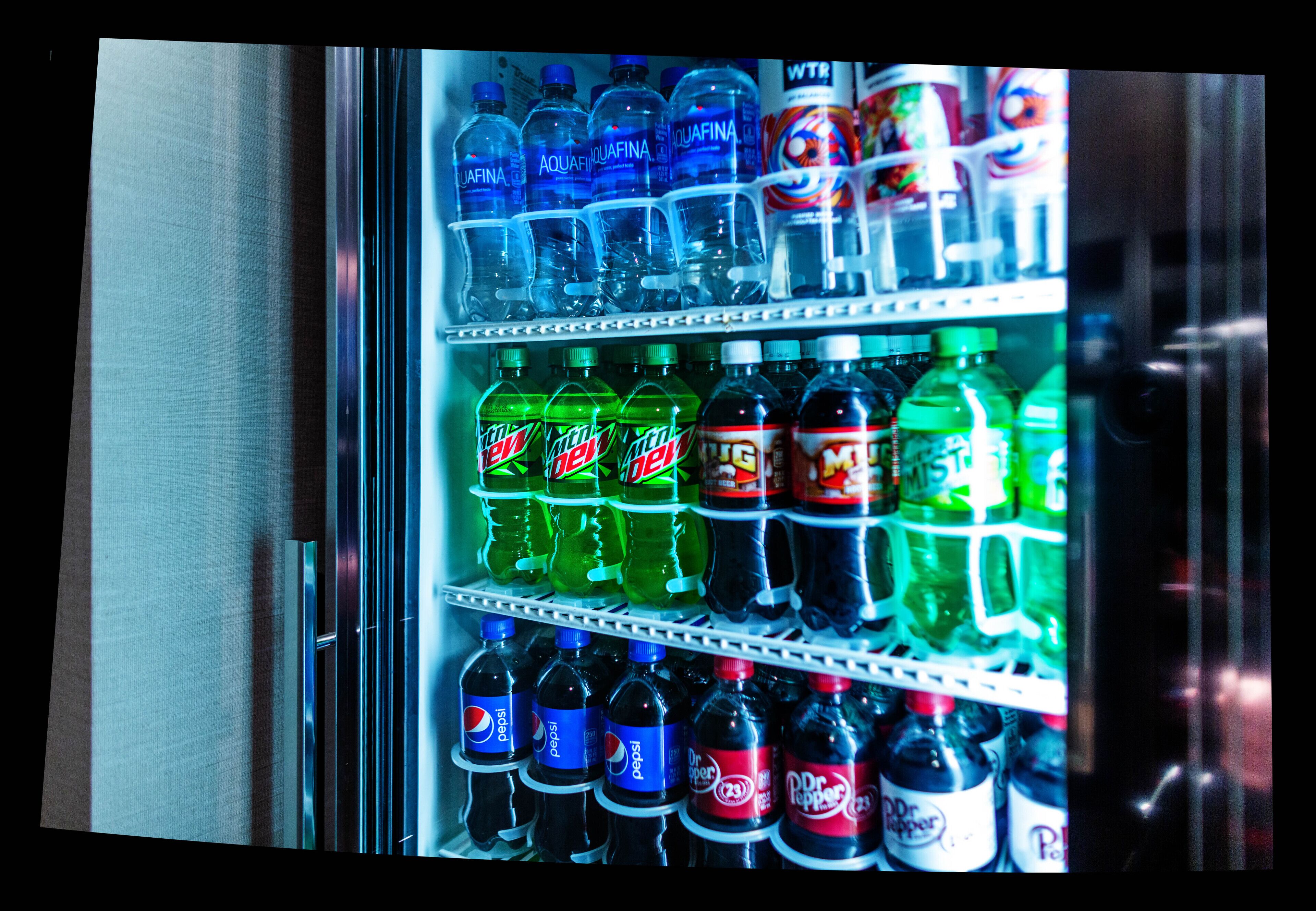 A vending machine stocked with various beverages including Aquafina, Mountain Dew, and Dr. Pepper.