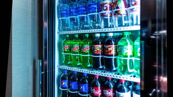 A vending machine stocked with various beverages including Aquafina, Mountain Dew, and Dr. Pepper.