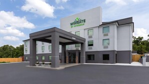 A modern building with a sign reading "Wingate by Wyndham." It features a covered entrance, multiple windows, and a parking lot. - Wingate by Wyndham Augusta I-20 (Augusta)