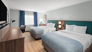 A hotel room with two beds, a desk, a TV, and a window with curtains. - Wingate by Wyndham Augusta I-20 (Augusta)