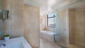 A modern bathroom with a bathtub, a glass-enclosed shower, and a view through the shower door.