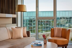 Signature Suite, 1 King Bed | Living area | Flat-screen TV, DVD player, iPod dock, pay movies