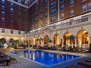 A hotel with a swimming pool, lounge chairs, and a courtyard with palm trees. -  The Royal Sonesta Chase Park Plaza St. Louis (St. Louis)