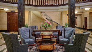 A grand lobby with a central seating area, a staircase, and a decorative ceiling. -  The Royal Sonesta Chase Park Plaza St. Louis (St. Louis)