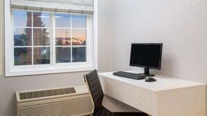 A room with a desk, computer, and window with a view of a cityscape. - Super 8 by Wyndham Ottawa (Ottawa)