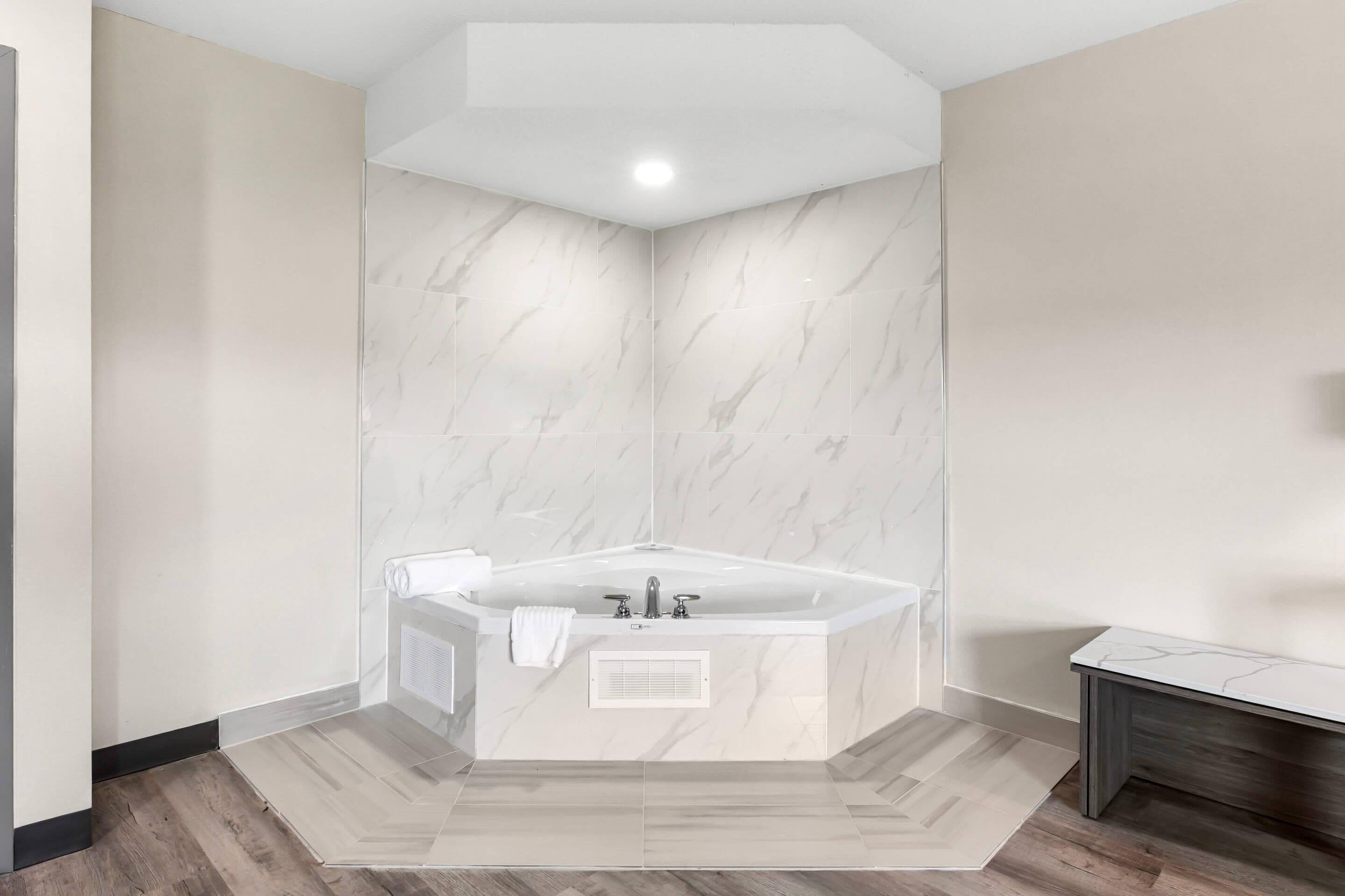 A modern bathroom with a freestanding bathtub, a built-in shower, and a vanity with a mirror.