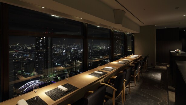 A modern conference room with a long table, chairs, and a city view through large windows. - RIHGA Royal Hotel Osaka, Vignette Collection by IHG (Osaka)