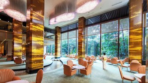 A spacious indoor area with large windows, modern seating, and decorative lighting. - RIHGA Royal Hotel Osaka, Vignette Collection by IHG (Osaka)