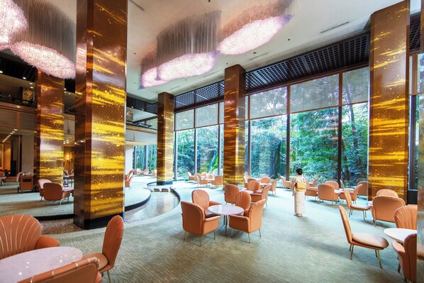 A spacious indoor area with large windows, modern seating, and decorative lighting. - RIHGA Royal Hotel Osaka, Vignette Collection by IHG (Osaka)