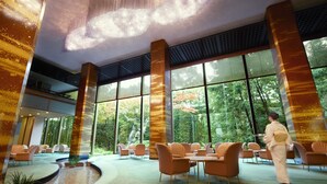 A spacious indoor area with large windows, a fountain, and several seating arrangements. - RIHGA Royal Hotel Osaka, Vignette Collection by IHG (Osaka)