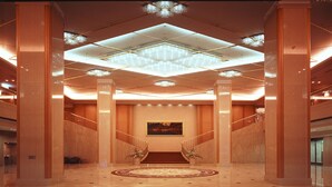 A spacious lobby with a grand staircase, a chandelier, and a large painting on the wall. - RIHGA Royal Hotel Hiroshima (Hiroshima)