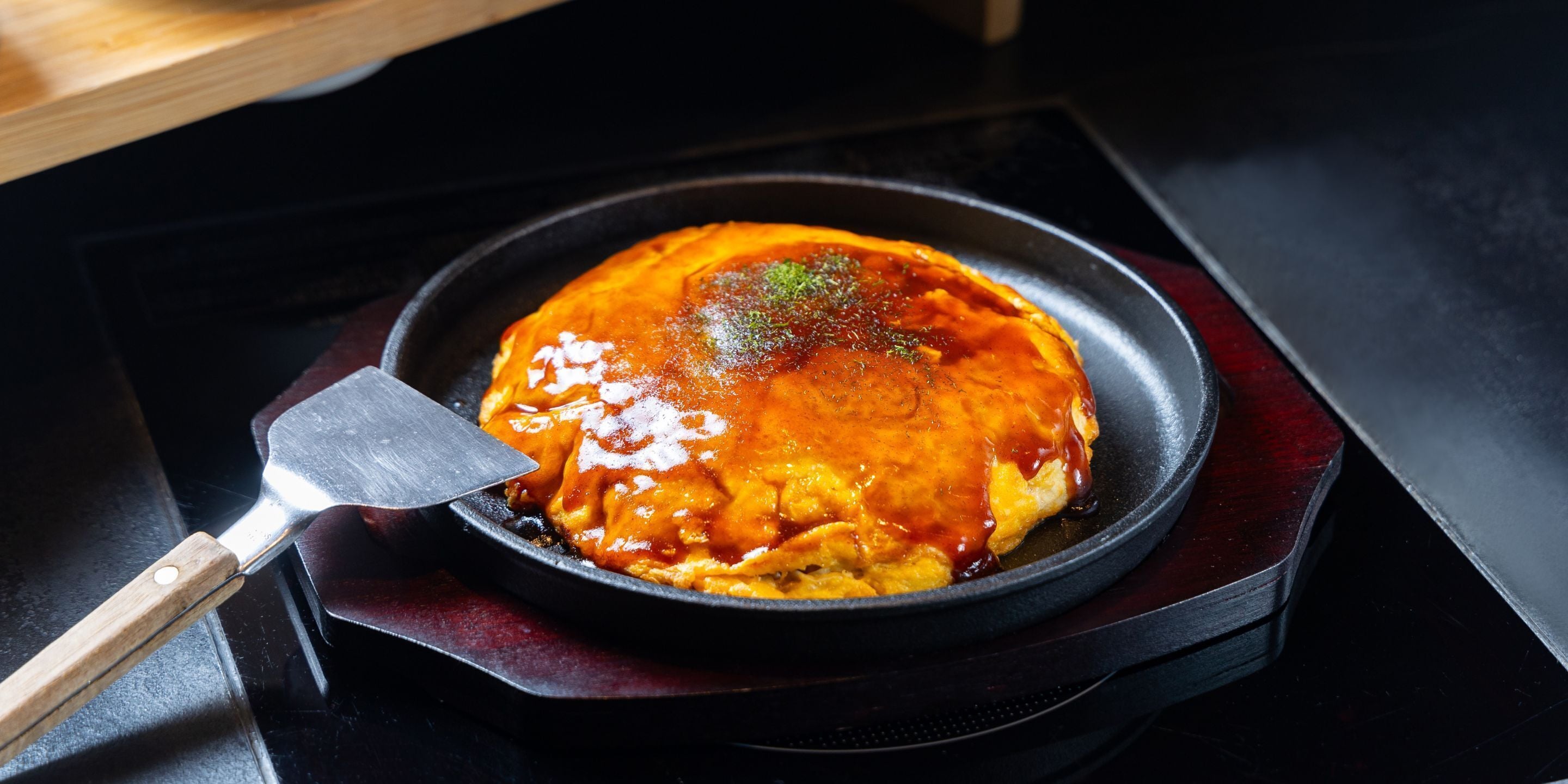 A dish in a pan on a stove.