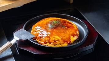A dish in a pan on a stove.