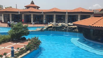 Outdoor pool, pool umbrellas, lifeguards on site