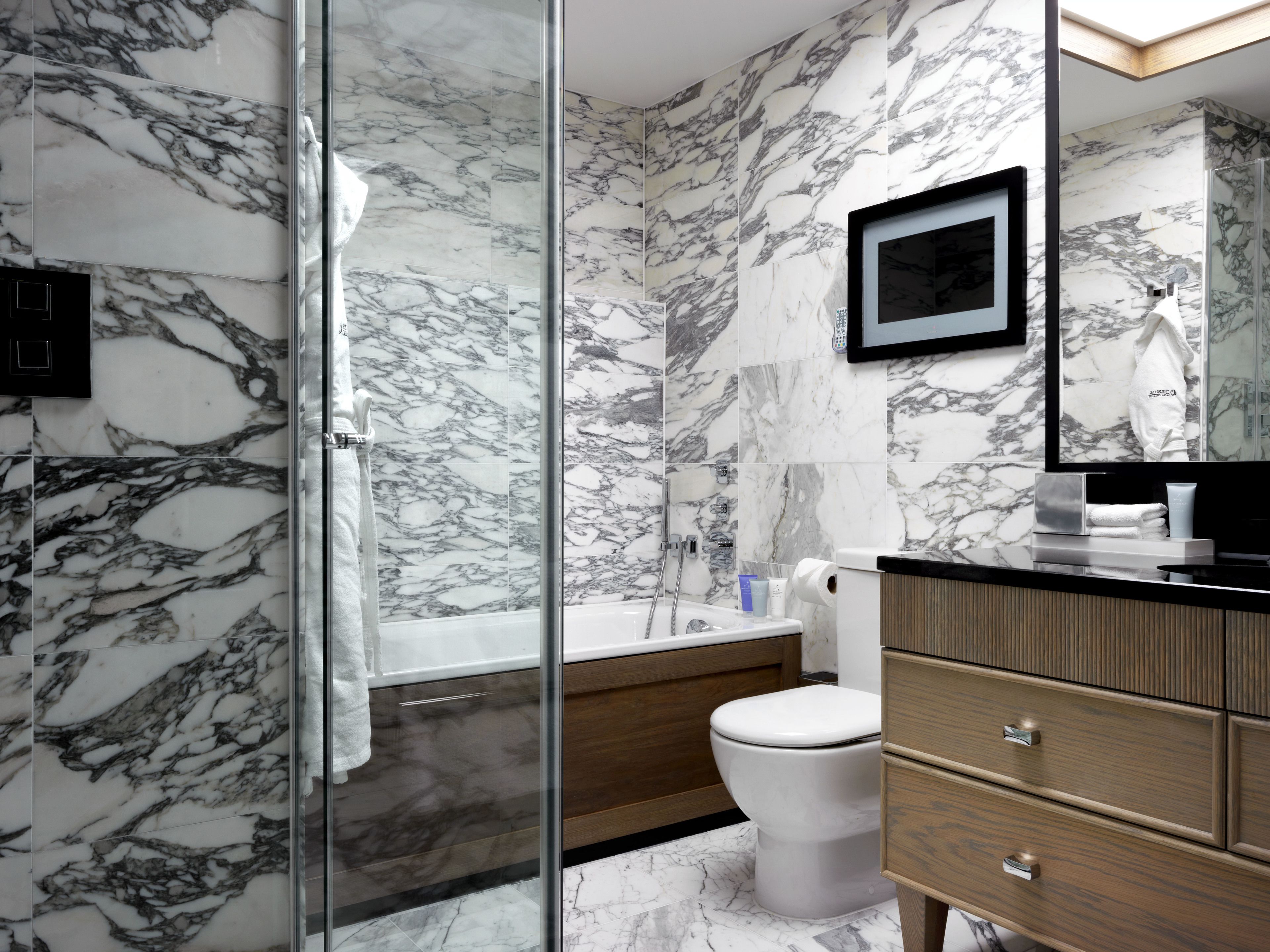 combined shower/bathtub, designer toiletries, hair dryer, bathrobes