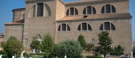 A historic building with a prominent central tower and arched windows.