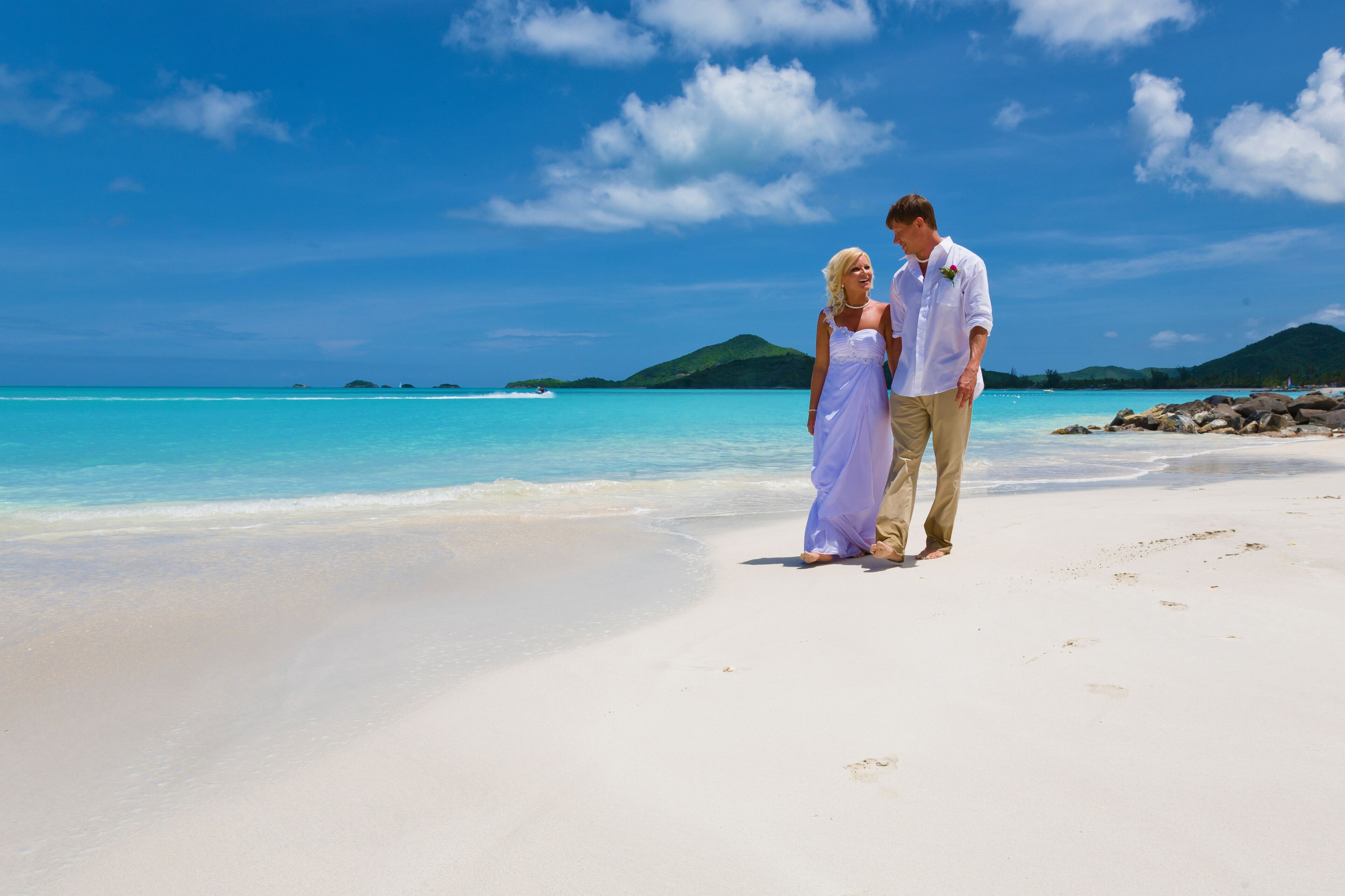 A beach with clear turquoise water and white sand.