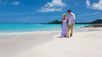 A beach with clear turquoise water and white sand.