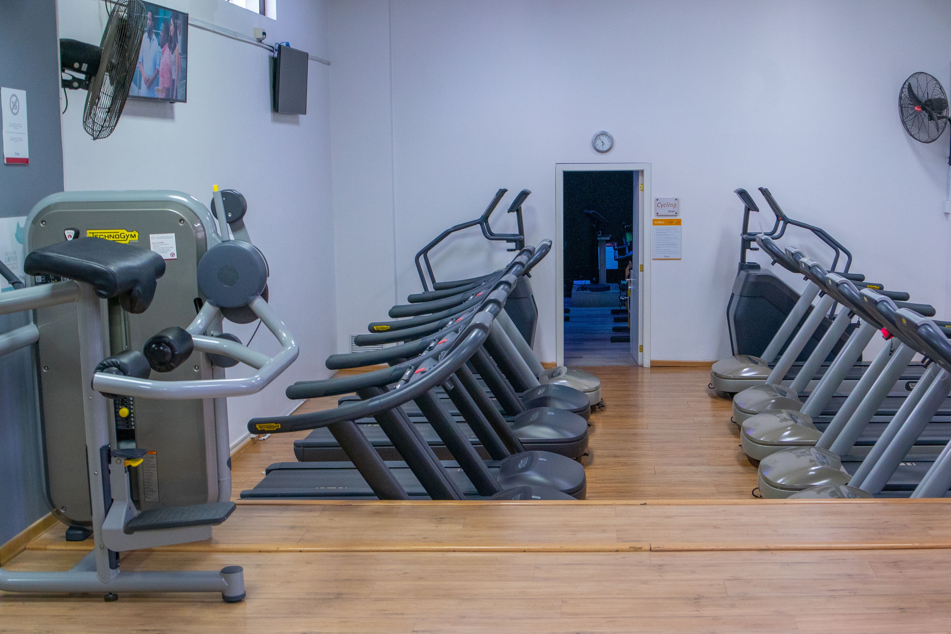 A gym with multiple treadmills and a stationary bike.