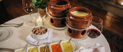 A dining table set with various dishes, including bowls of soup and a plate of bread.