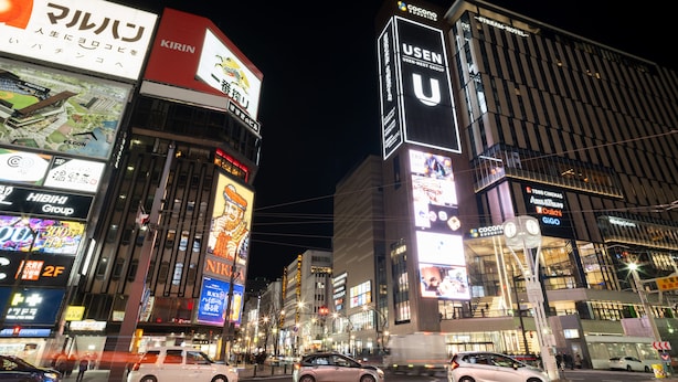A nighttime cityscape with illuminated billboards and buildings, including a prominent 'USEN' sign. - Sapporo Tokyu REI Hotel (Sapporo)
