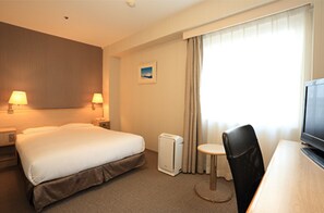 A hotel room with a large bed, two bedside lamps, a small table with a chair, a television, and a window with curtains. - Smile Hotel Shimonoseki (Shimonoseki)
